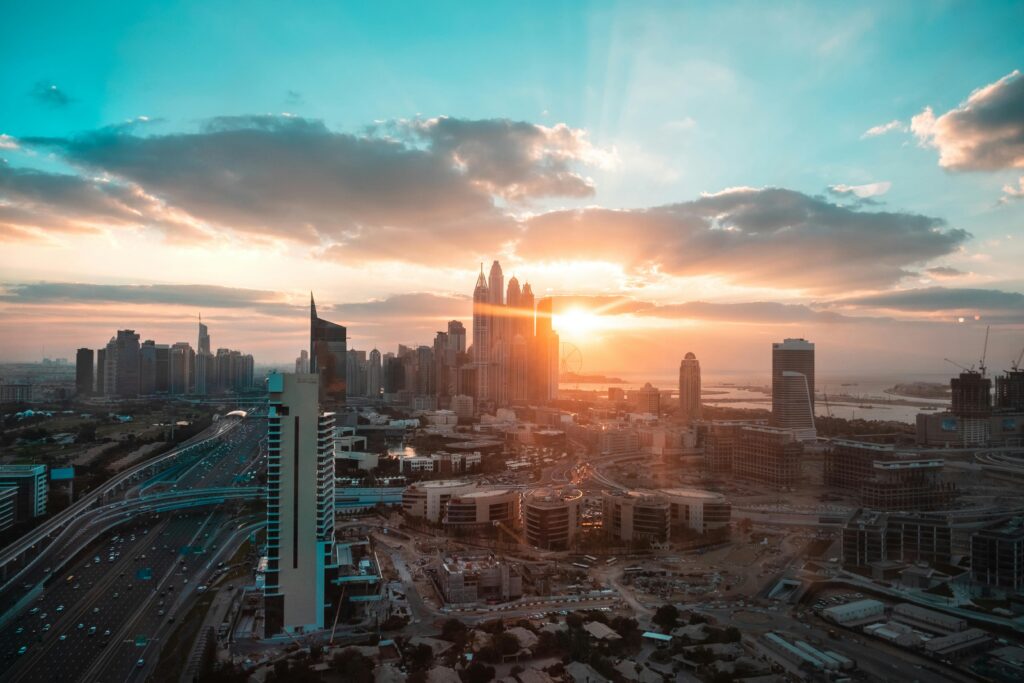 Aerial view of luxury holiday homes in Downtown Dubai with skyline and sunset in background