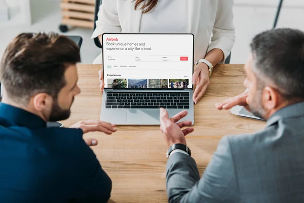 Discussing Airbnb setup on a laptop.