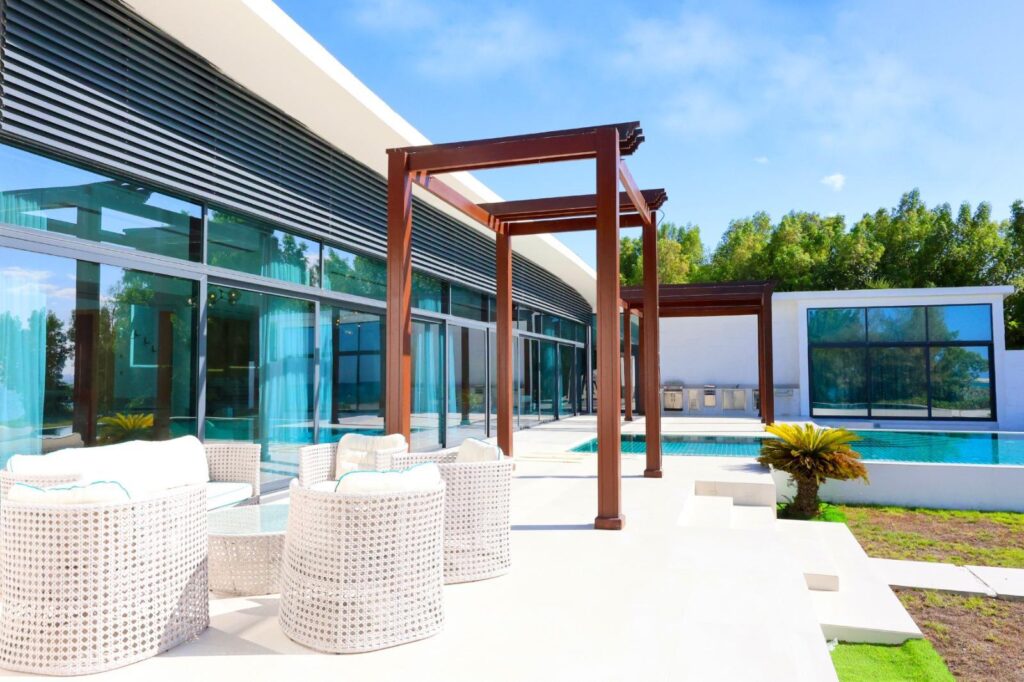 Peaceful ocean view from inside a Nurai Island villa, with cozy seating and coffee setup offering a serene space to relax and unwind.