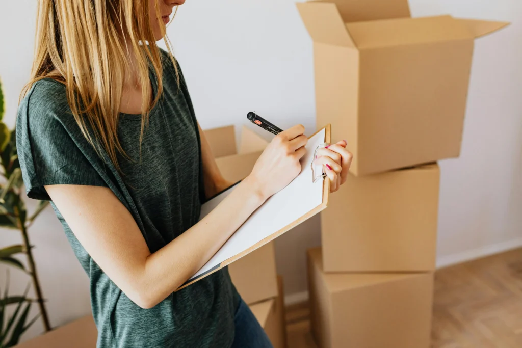Woman checking list with pet in Dubai apartment